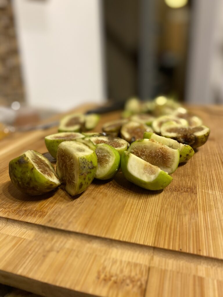 sliced figs on a wood cutting board