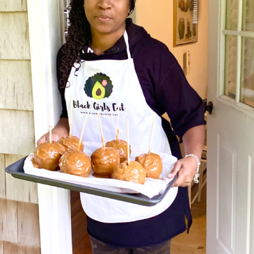 Woman Holding Tray of Caramel Apples