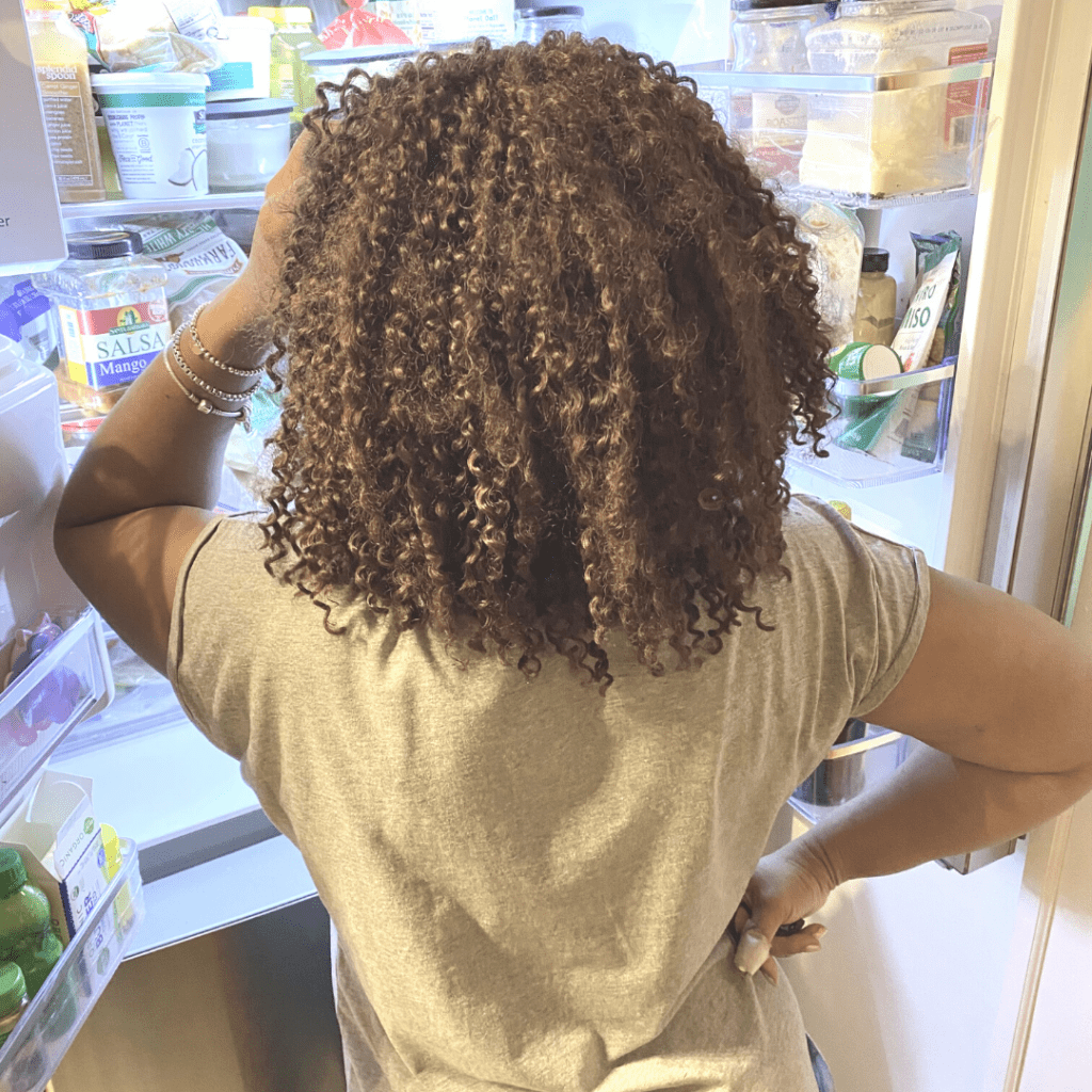 Woman Looking Into Open Refrigerator