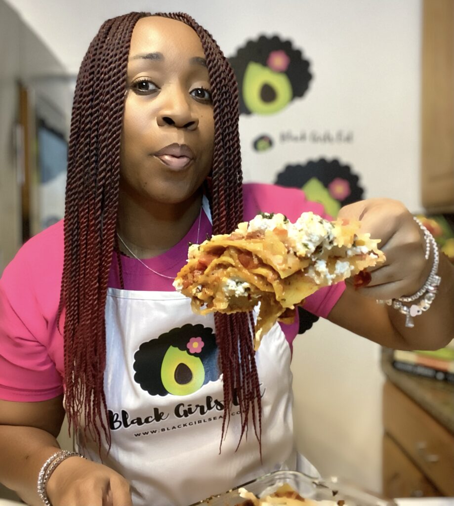 Woman holding a large serving of lasagne
