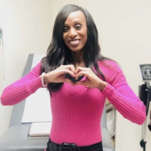 Dr Maggie Cadet Making the Heart Sign With Her Hands