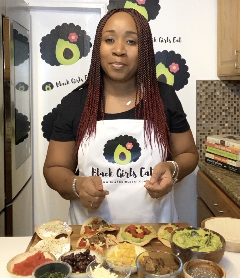 Plant based advocate LA Dunn in the kitchen with an assortment of tostadas