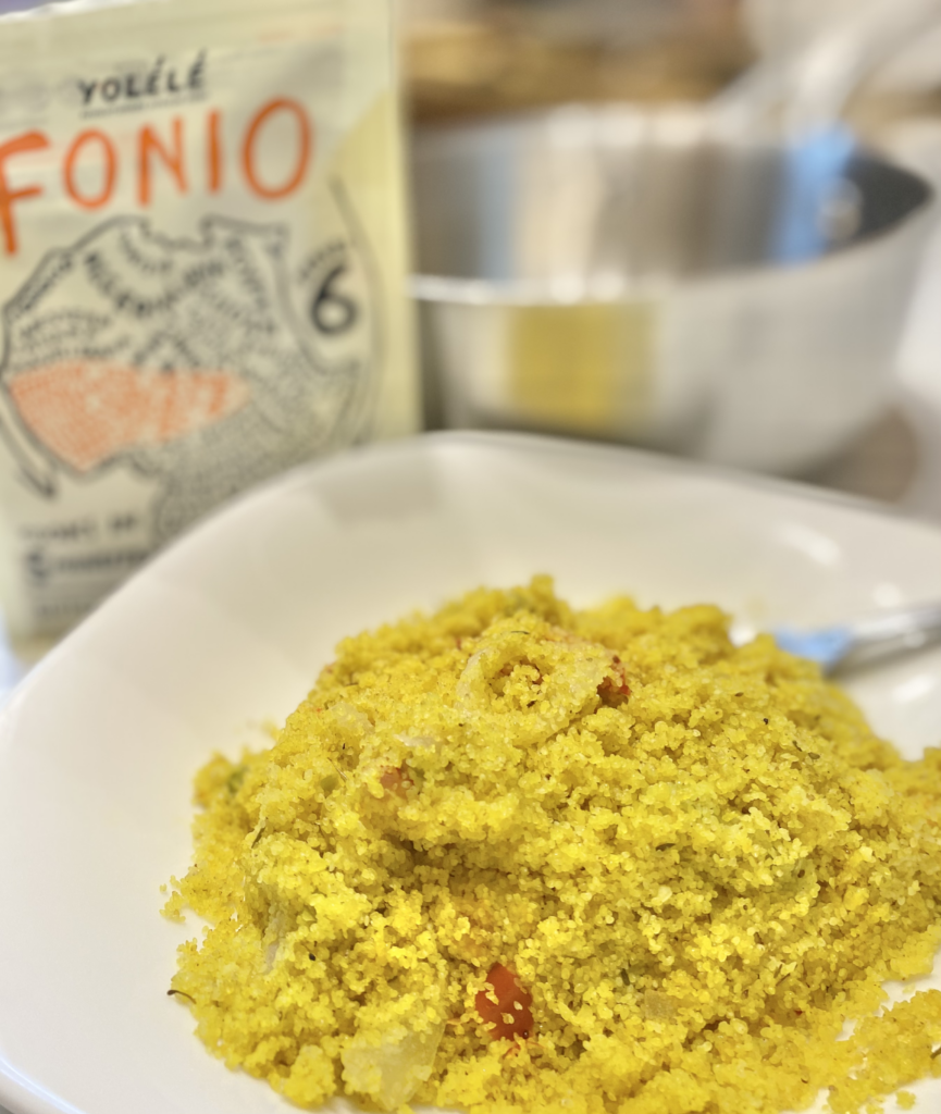 Bowl of Coconut Fonio with Tumeric Peppers and Onions