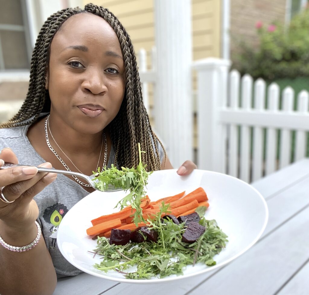 LA Dunn with a plate of carrots, beets and mixed spring greens from her garden