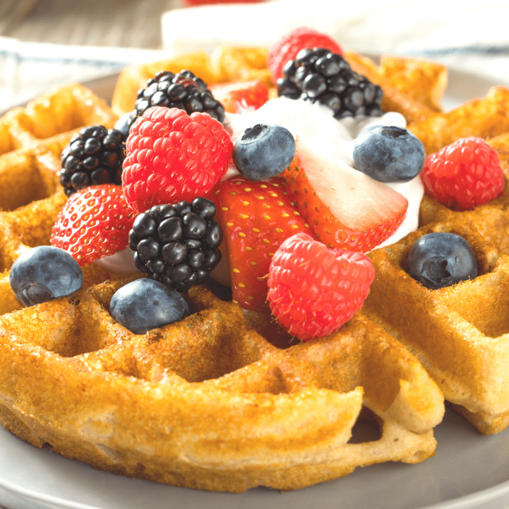 Belgian style waffles with fruit on a plate