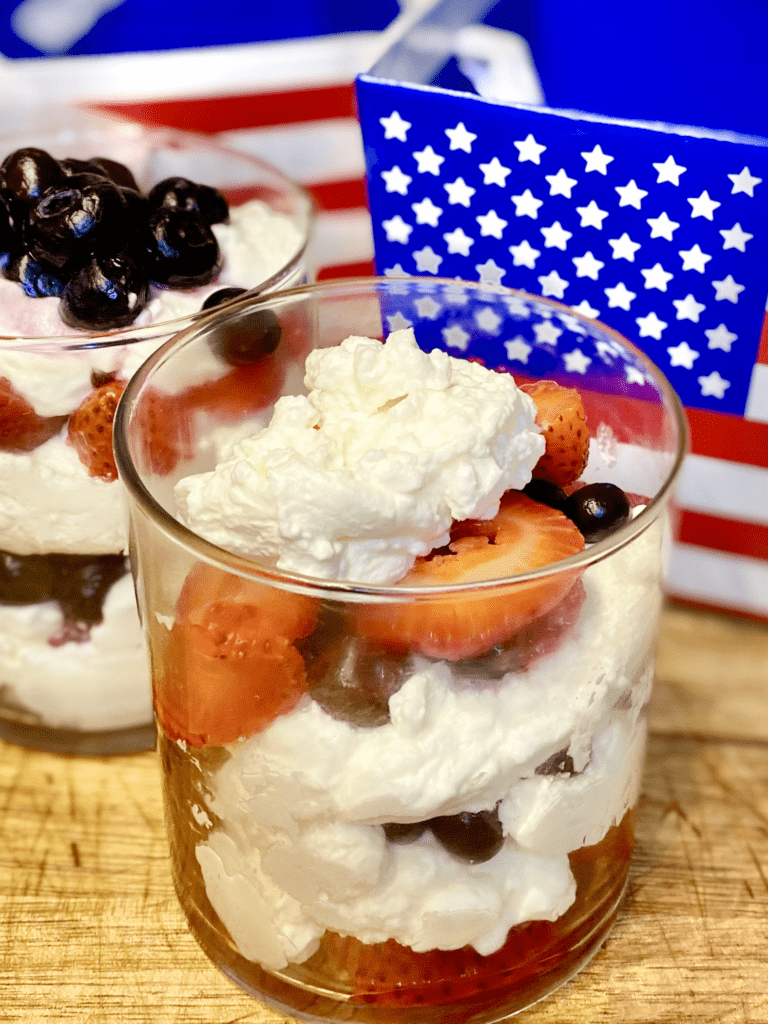Parfait with whipped cream, strawberries and blueberries