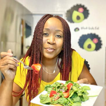Woman holding a plate of watermelon strawberry basil salad