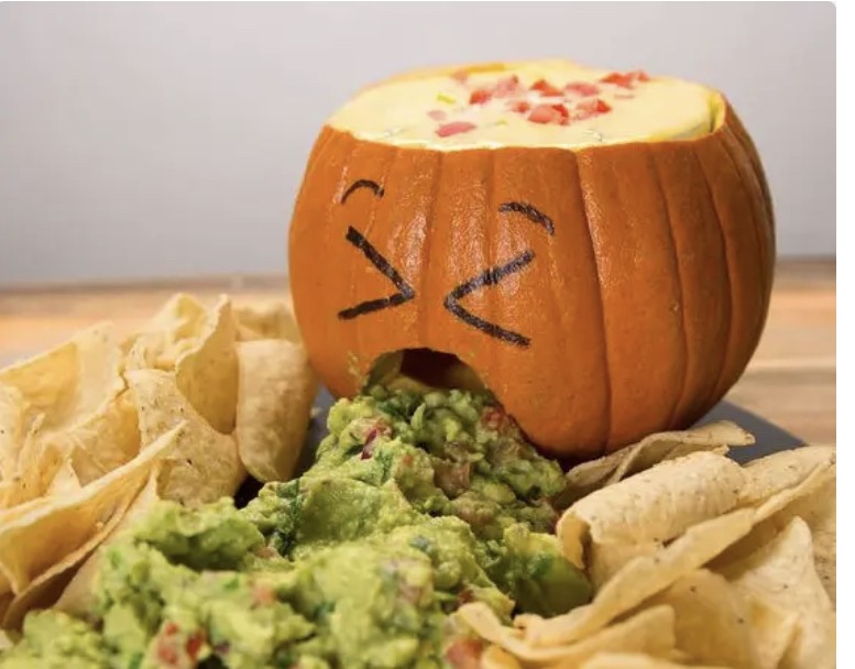 Carved pumpkin with guacamole coming out of the mouth