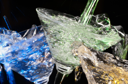 blue, green and gold liquid splashing martini glasses