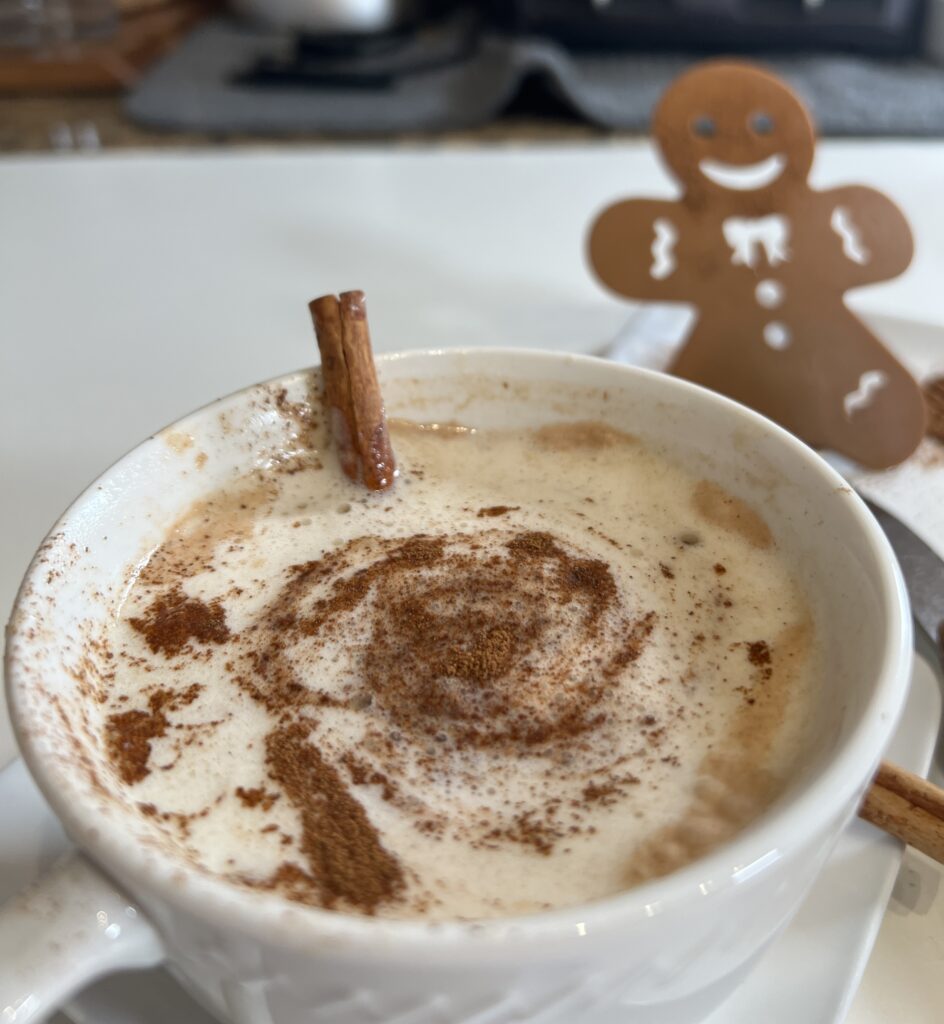 Cup of oat nog with cinnamon and cinnamon stick