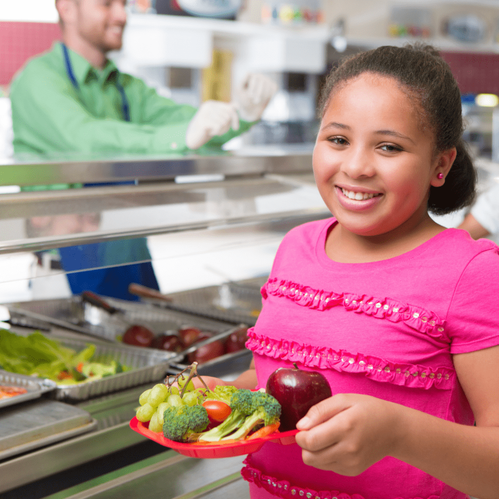 School Age Girl on School Cafeteria Line with Vegetarian Choices