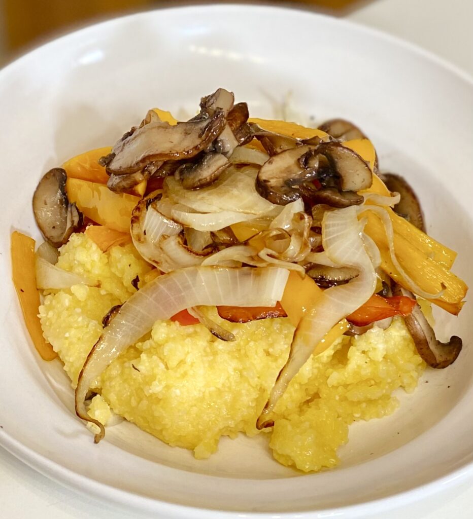 bowl of polenta, mushrooms, peppers and onions