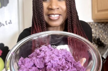 Woman holding bowl of mashed purple potatoes