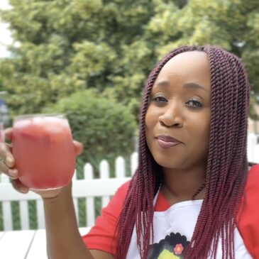 Woman with glass of Red Juneteenth Punch