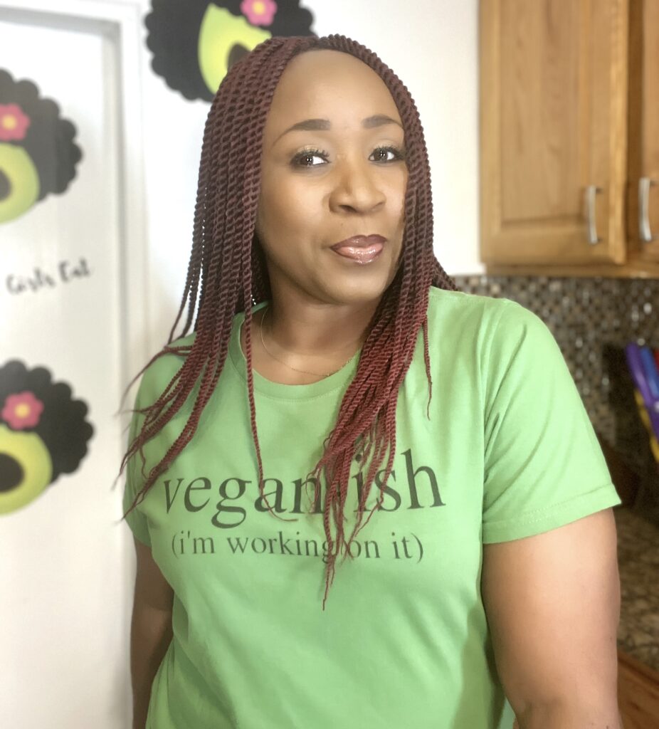 Woman in kitchen wearing tshirt that says Vegan-ish
