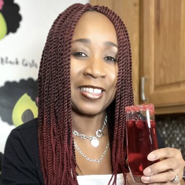 woman holding glass of prosecco with cranberry juice and cranberries