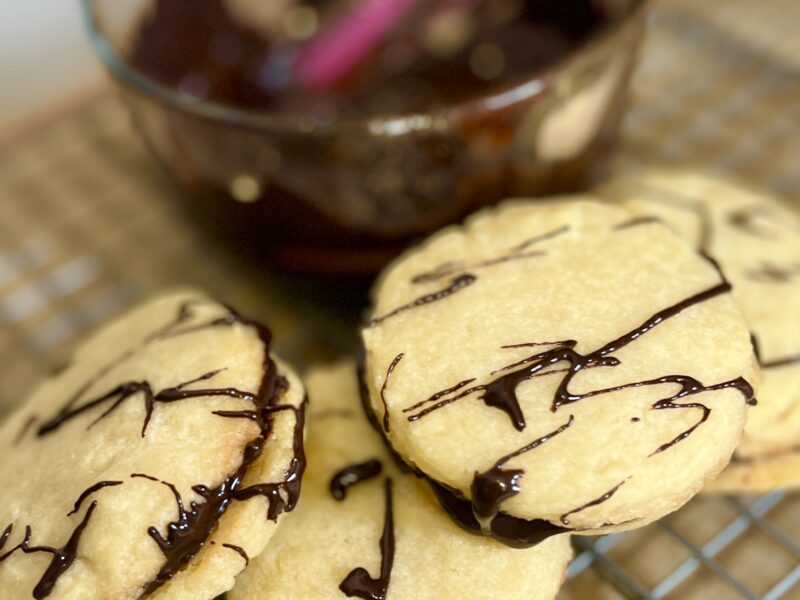 Chocolate Hummus Cookies next to a bowl of chocolate hummus with a pink spatula