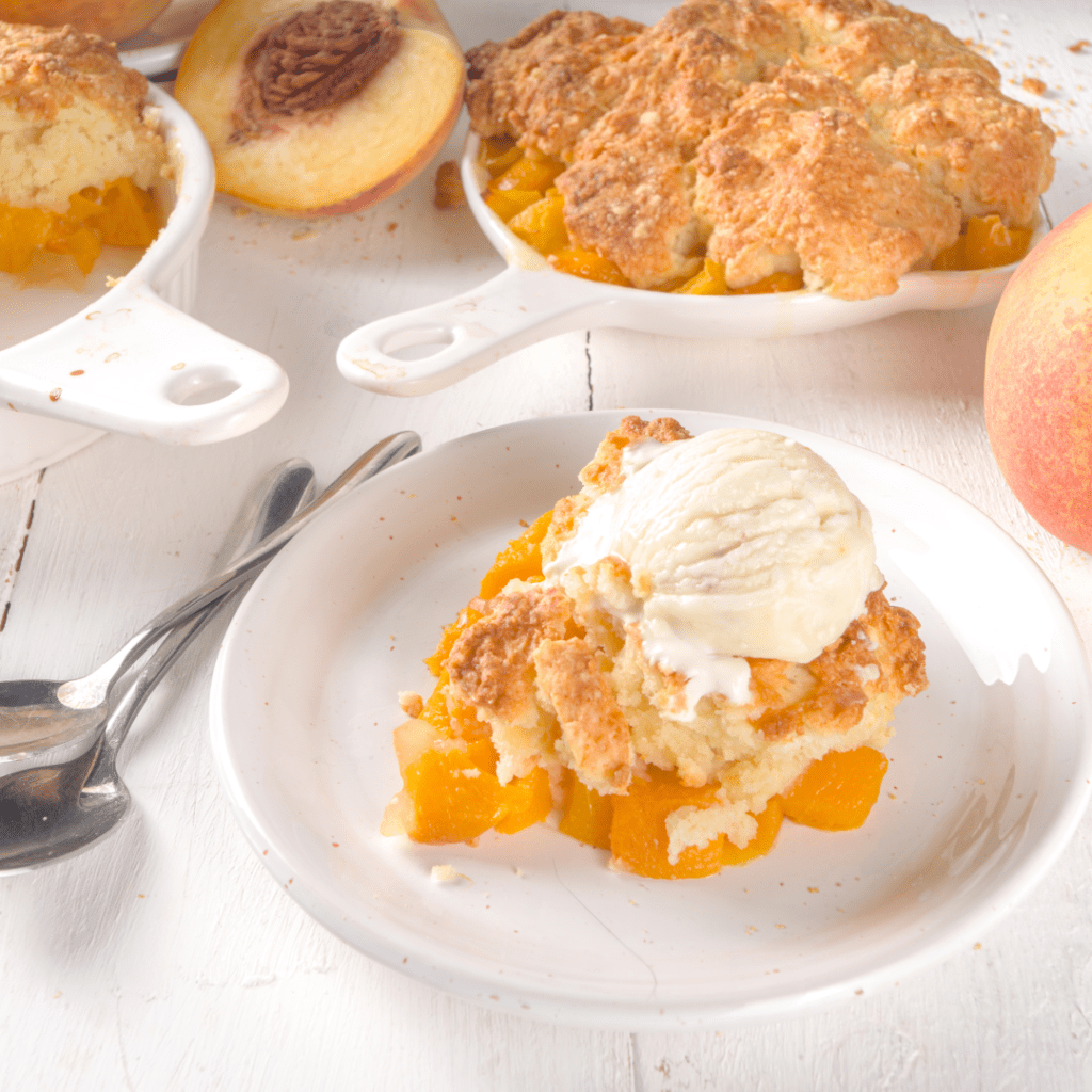 Plate of peach cobbler with a scoop of ice cream on top is one of the popular holiday desserts