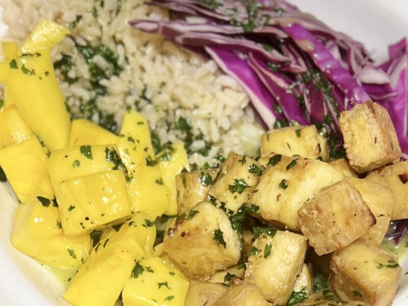 Bowl of rice, spicy tofu, red cabbage and mango
