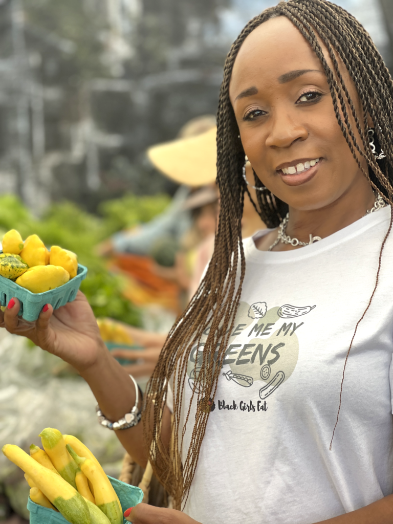 woman holding produce at farmers market