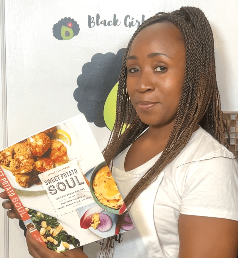 woman holding a cop of sweet potato soul vegan cookbook