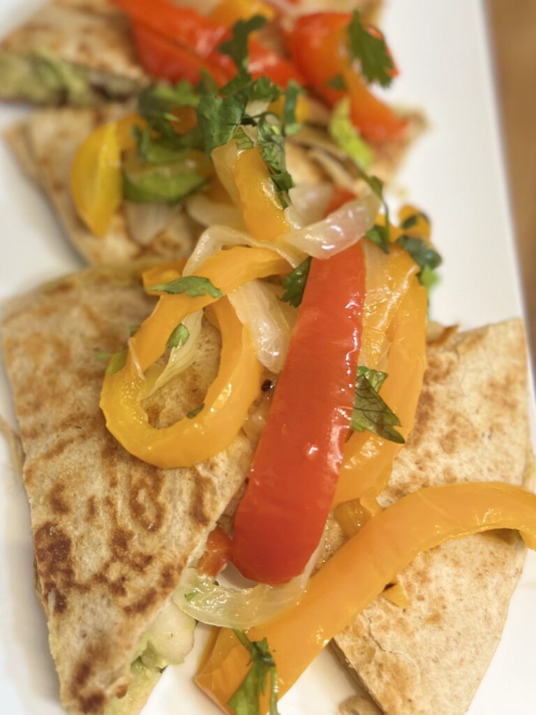 cheese free quesadillas with peppers and onions on a plate