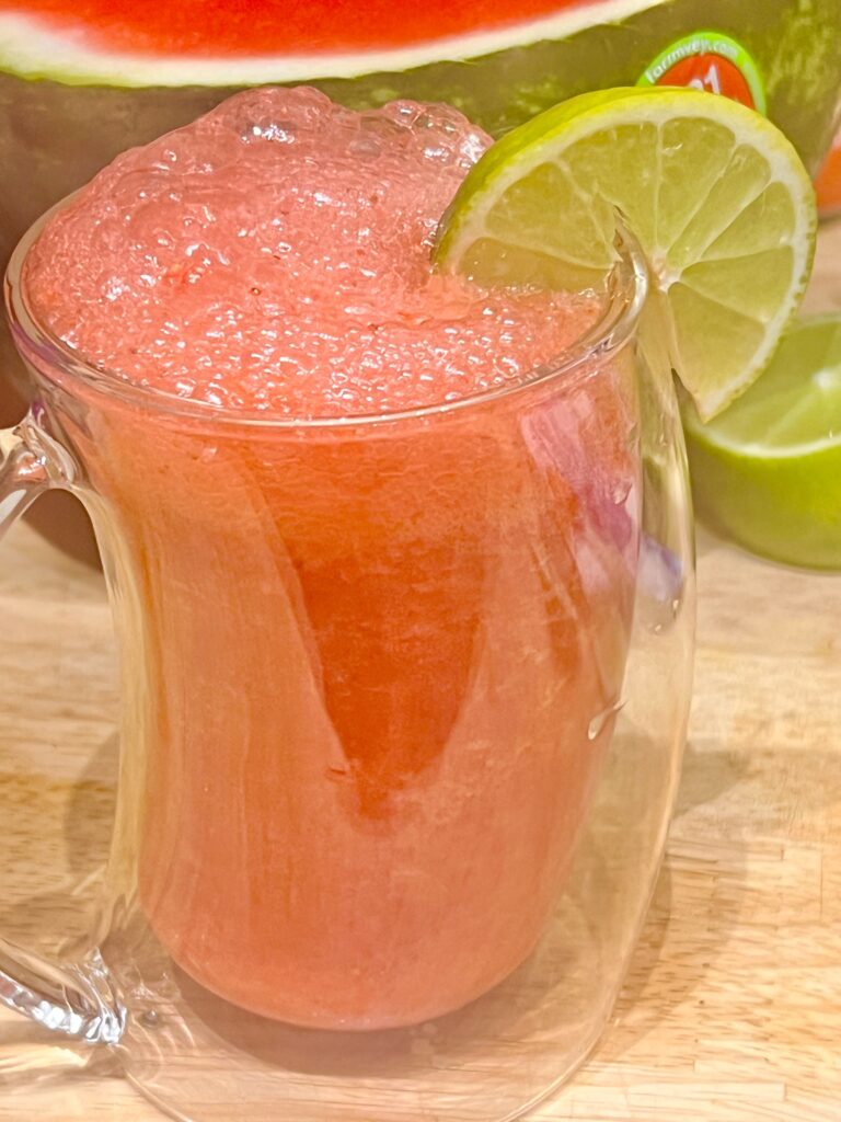 agua fresca in a glass with lime on the rim