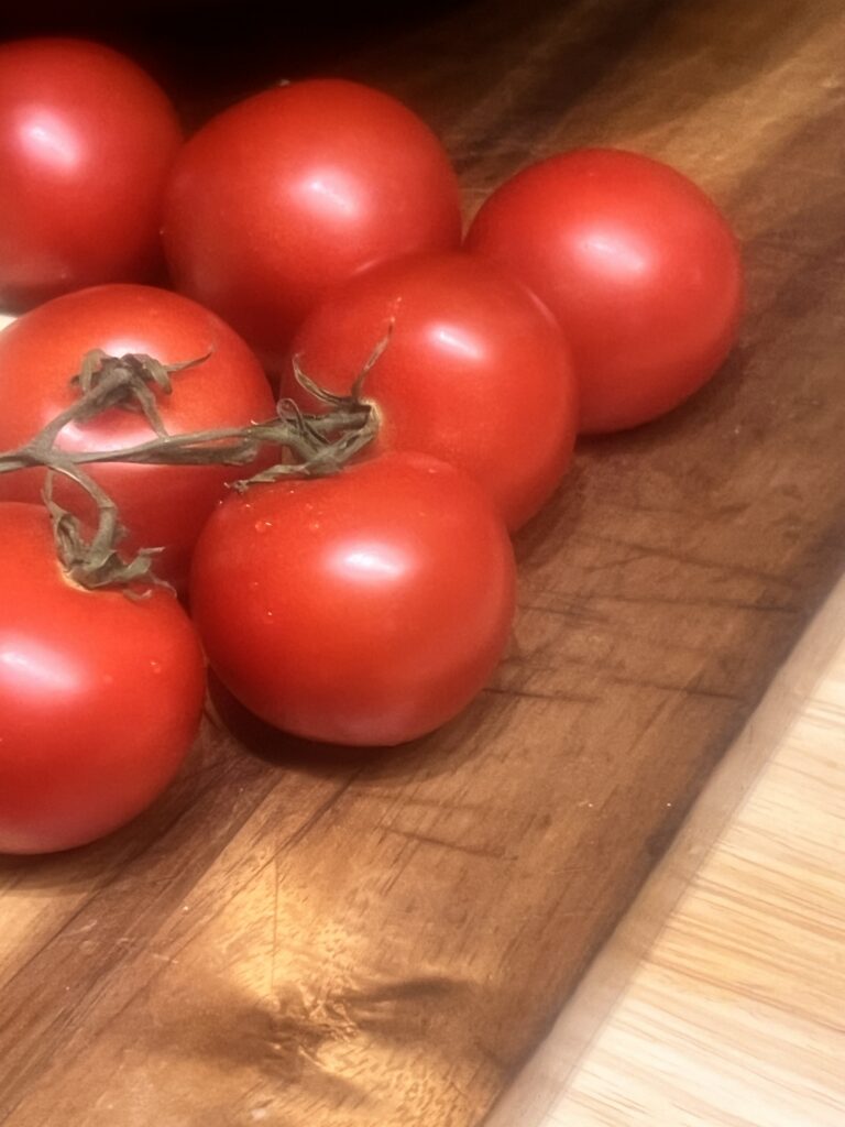 Several beefsteak tomatoes on a table