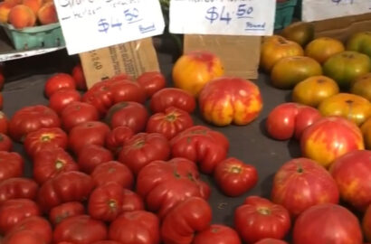 Red heirloom tomatoes on a table at the supermarket