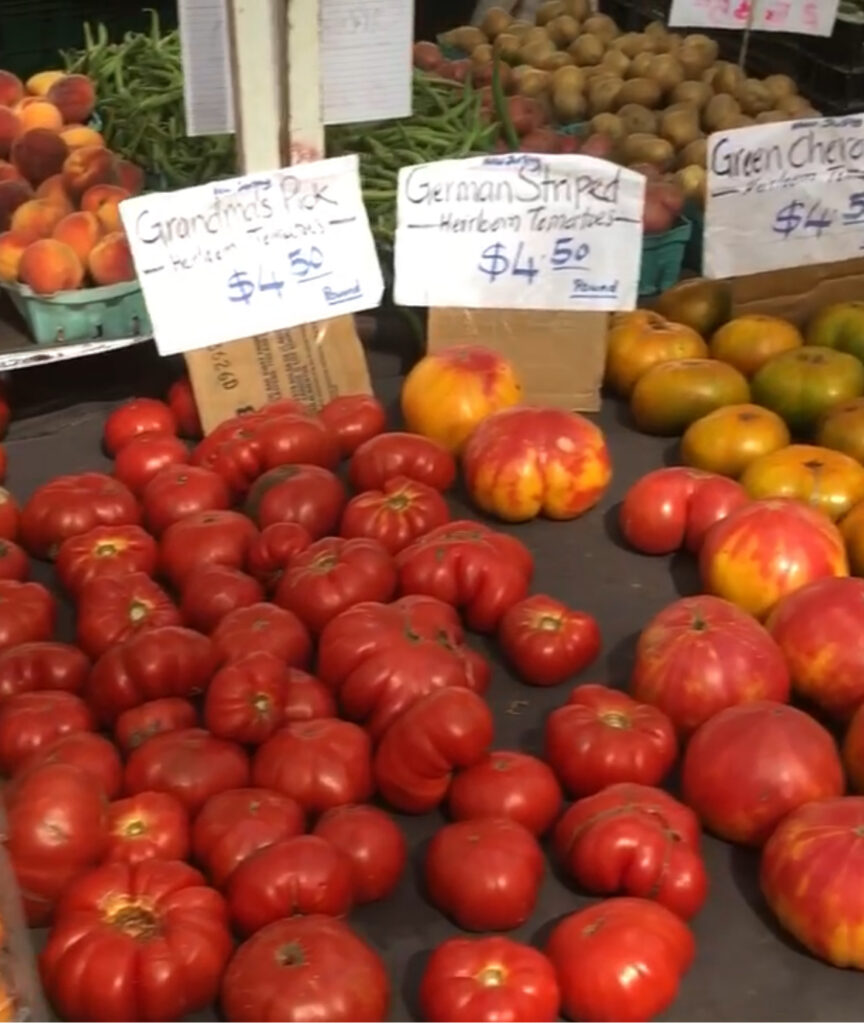 Red heirloom tomatoes on a table at the supermarket