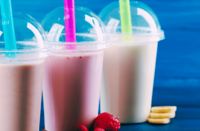 3 Milkshakes in plastic cups with straws