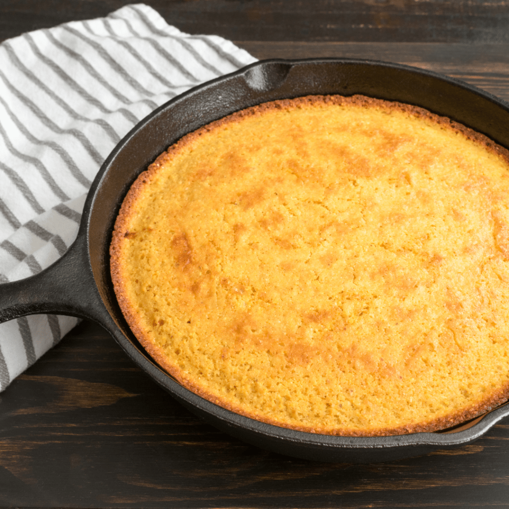 a caste iron pan with fresh cornbread