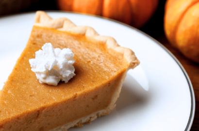 A slice of pumpkin pie on a plate