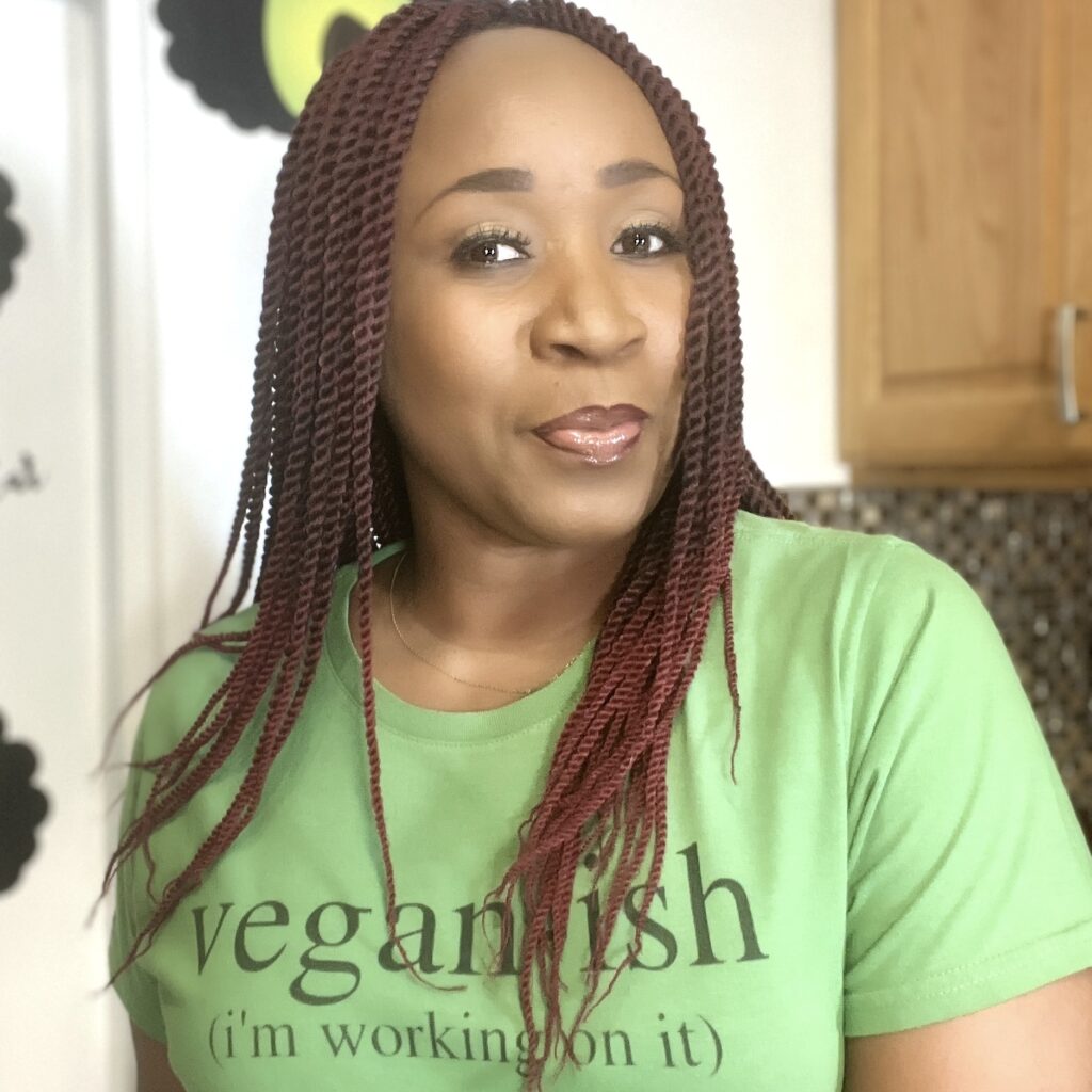 woman in green shirt with black letters that read: vegan-ish (I'm still working on it)