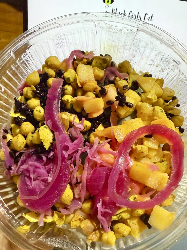 Bowl of Tropical Salad with pickled cabbage, yellow corn and black beans