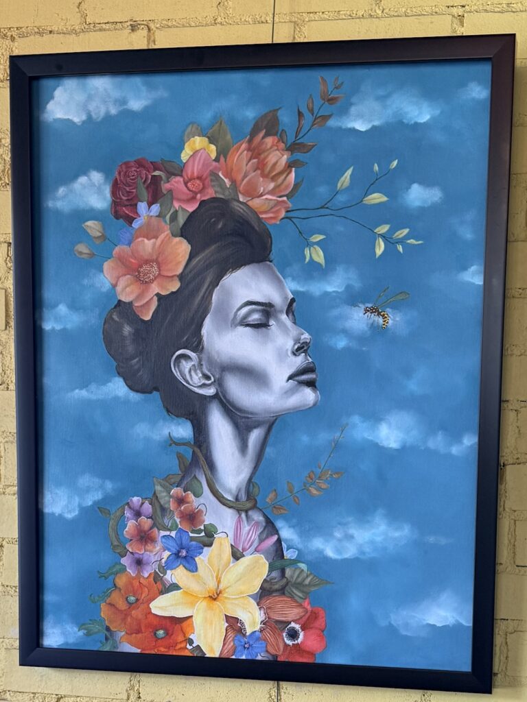 Colorful painting of a woman with flowers in her hair