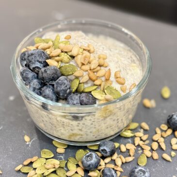 Bowl of Banana Chia Seed Pudding topped with blueberries, pumpkin seeds and sunflower seeds