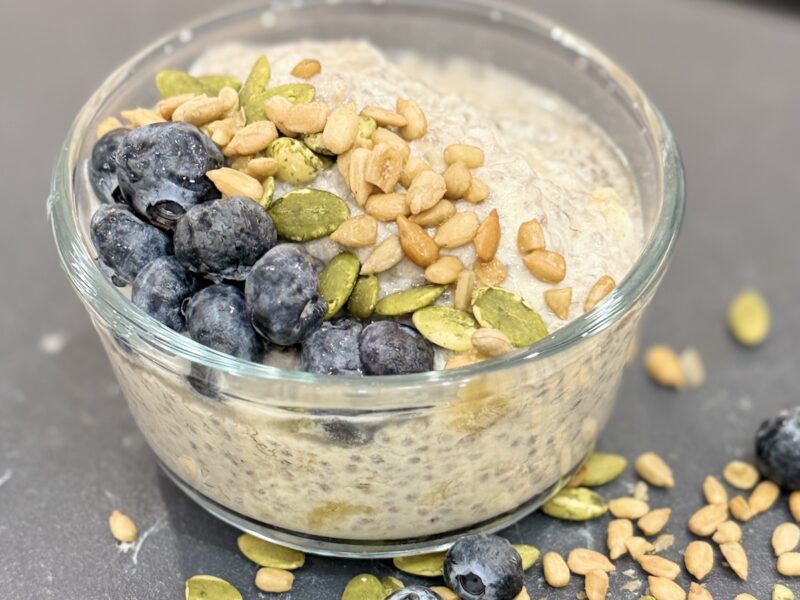 Bowl of Banana Chia Seed Pudding topped with blueberries, pumpkin seeds and sunflower seeds